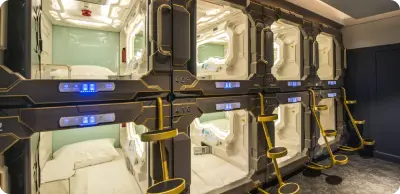 Capsule rooms equipped with comfortable beds, personal lighting and power outlets, air conditioning. Common areas include showers, a kitchen and a lounge.